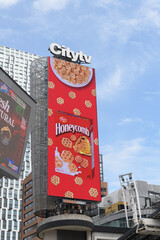 Naklejka premium Citytv sign a top digital billboard at Sankofa Square featuring ad for Honeycomb cereal, Toronto