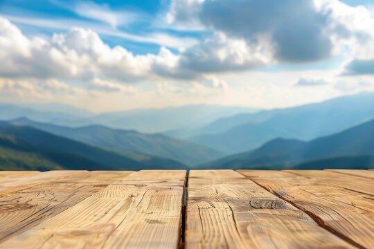 Wooden table surface with blurred mountain landscape in background