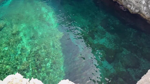 Mirror-like calm turquoise water surface in a quiet bay, Malta