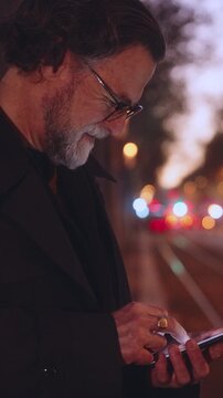 Smiling Mature man using smartphone for online banking, modern applications and convenience of fast 5G connection. Technology enhances efficiency in connected digital world, taxi app on cellphone
