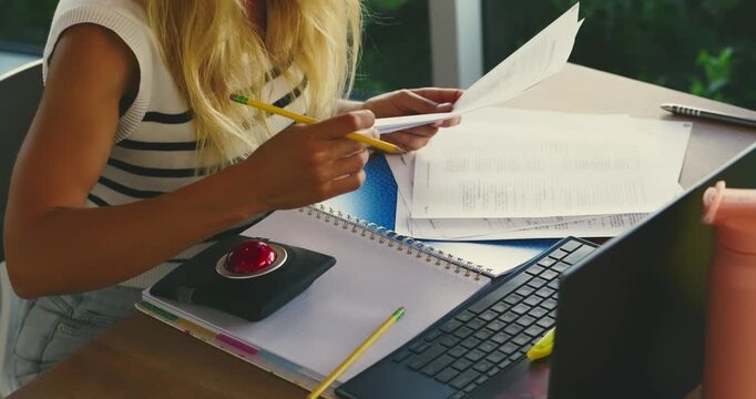 Woman Organizing Papers at Desk in Office