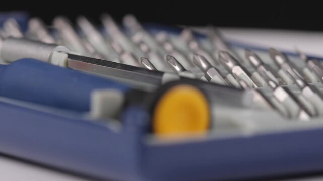A set of metal bits for installation work in a plastic case.