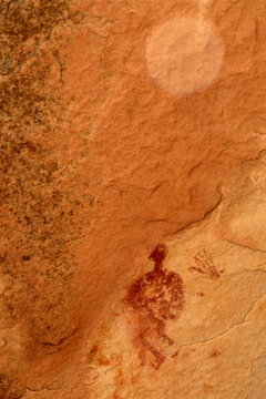 Ancient red pictograph of a figure on sandstone in Galisteo Basin, New Mexico