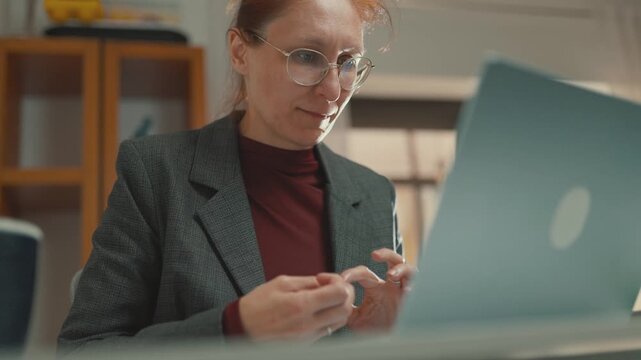 Stressed businesswoman nervously fidgeting with her fingers