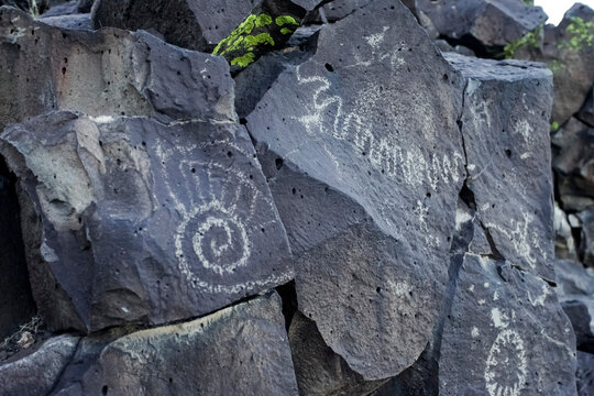 Ancient petroglyphs carved into stone in Santa Fe