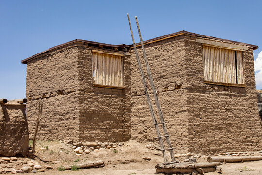 Traditional adobe structure with ladder on pueblo in New Mexico