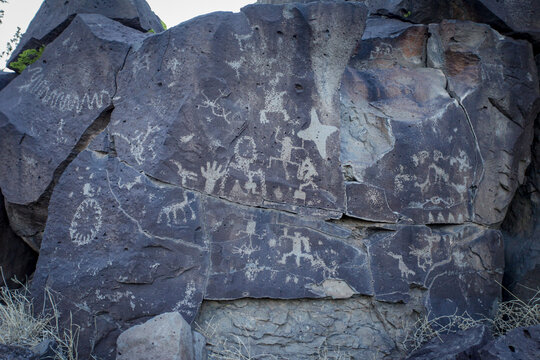 Ancient petroglyphs carved into dark volcanic rock