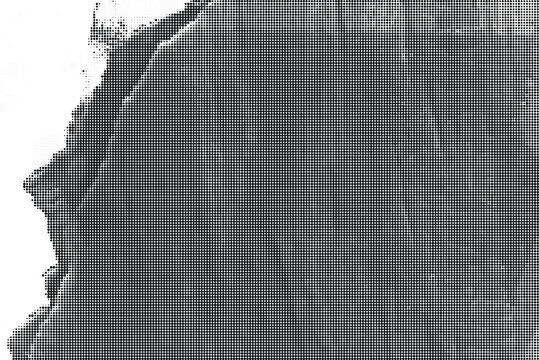 A close-up view of a textured, ripped, and weathered dark surface