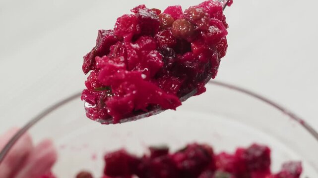 Russian beetroot vinaigrette salad with green peas, boiled vegetables and dill, close up in restaurant. 