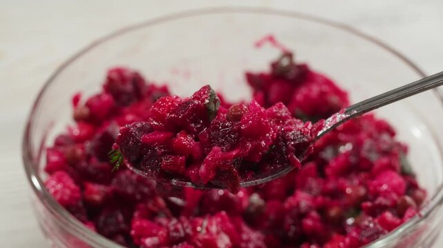 Russian beetroot vinaigrette salad with green peas, boiled vegetables and dill, close up in restaurant. 