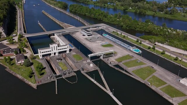 Lock on River Maas near Maastricht shows barge navigating Ecluse de Lanaye at the border of Belgium and the Netherlands