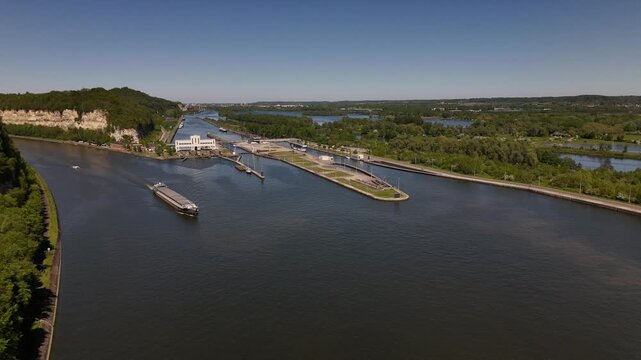 Lock on the River Maas near Maastricht with barge passing through Ecluse de Lanaye between Belgium and Netherlands