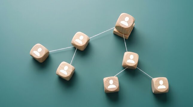 Wooden blocks with human icons connected by lines on green background