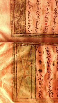 Static macro shot of an ancient Quranic manuscript showing verses from Surah Al-Baqarah in elegant Arabic calligraphy.