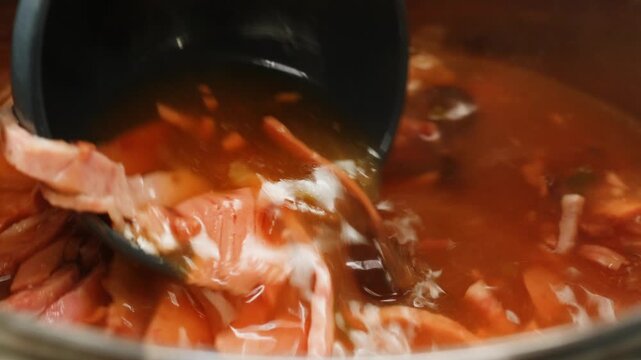 Slavic meat soup, Solyanka sausages soup with sour cream white bowl food, close up of winter soup with ham