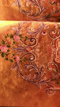 Detailed static view of an ancient Quranic frontispiece with intricate geometric and floral illumination in gold and red.