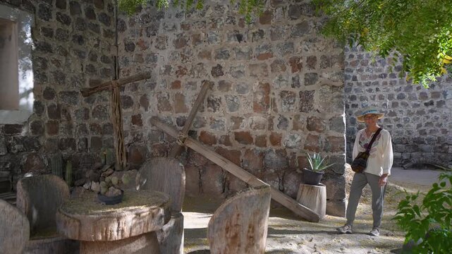 Mature woman sightseeing at Mission Church in San Ignacio, Baja California, Mexico, exploring the area and appreciating the architecture