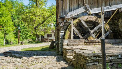 Old wooden water wheel at a historic mill © Sandris Veveris