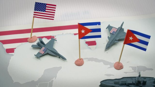 Conceptual representation of the diplomatic crisis and military tensions between the United States and Cuba, with flags, fighter jets, and an aircraft carrier symbolizing the threat of war
