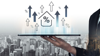 A businessman presents a tablet displaying growth icons and house graphics over a cityscape, symbolizing real estate market trends and financial analytics. Gantry © InfiniteFlow
