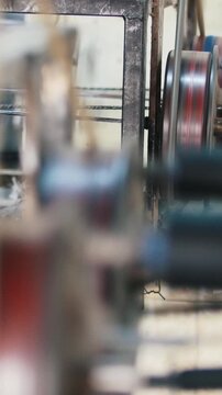 Manufacturing of fiberglass reinforcement - machine is spinning the optical fiber wire