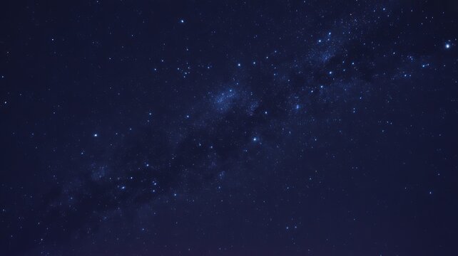 Dark blue night sky with scattered white stars and subtle cloud formations in deep space