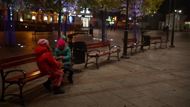 Two little beautiful girls walk Square in Sopot