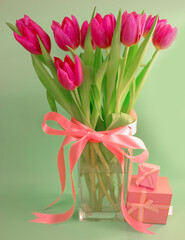 Fototapeta premium Pink tulip bouquet with ribbon and copy space, Mother’s Day appreciation and Women’s Day theme