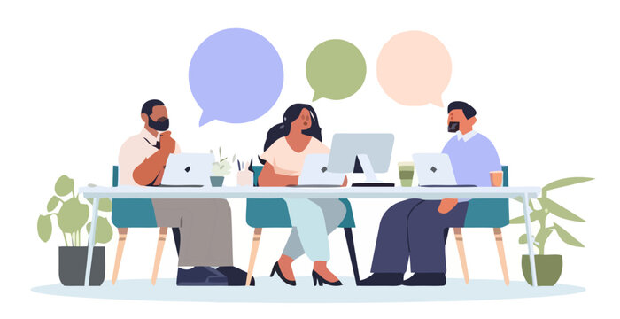 People discuss and collaborate on laptops in an office setting indoors.