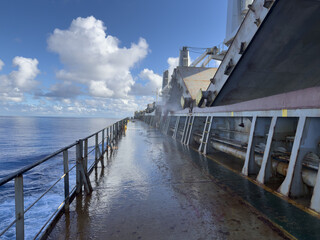 Fototapeta premium main deck of the cargo ship. hatch covers opened by pyramid for ventilation. blue sky and white clouds 