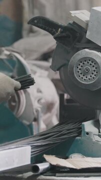 Manufacture of composite fiberglass reinforcement - worker cuts wires and counting production