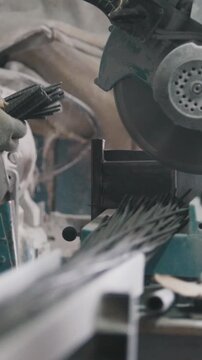 Manufacture of composite fiberglass reinforcement - worker cuts wires and counting production