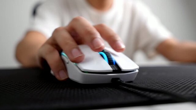 close up of person using ergonomic wireless computer mouse with blue scroll wheel on sleek black desk in modern workspace with soft natural lighting creating focused professional productivity