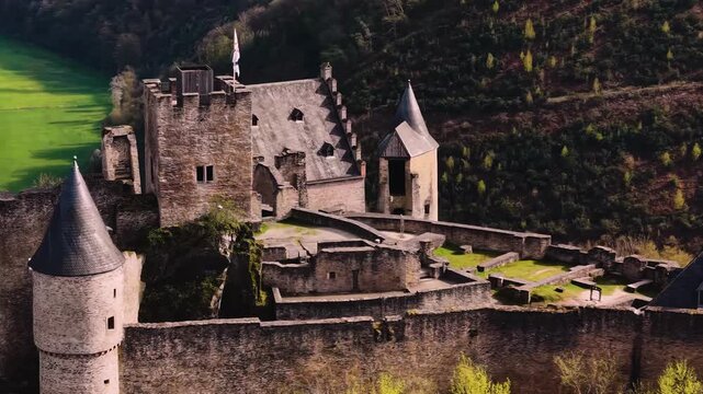 A panoramic Aerial view of the city and castle Bourscheid in Luxembourg, on a sunny spring noon