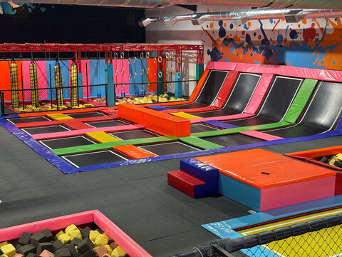 colorful indoor trampoline park with ninja park, foam pits, concept of entertainment, fitness, recreation, banner