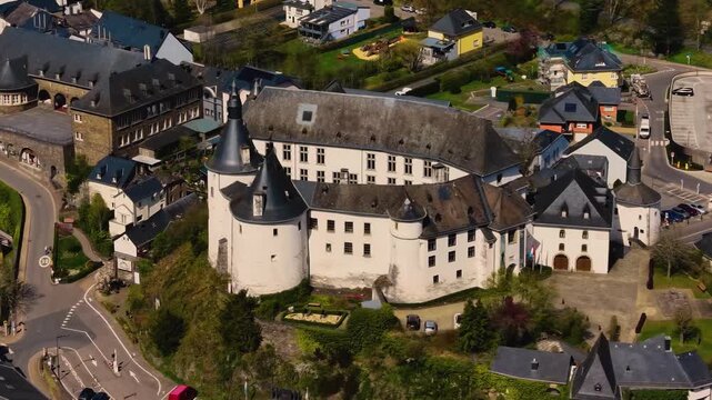 A panoramic Aerial view of the city and castle Clervaux in Luxembourg, on a sunny spring noon