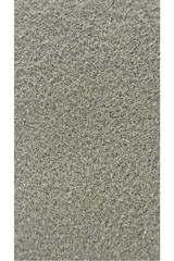 Fototapeta premium Gray sand texture fills the frame completely with uniform small grains creating a neutral and minimalist background perfect for creative design work, product display, or text overlays in professional.