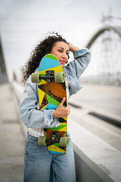 young woman on the walkway with skate