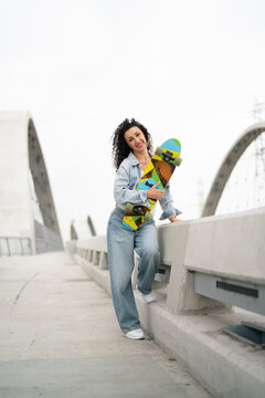 young woman on the walkway with skate