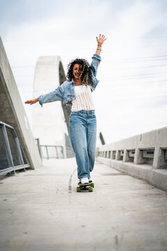 young woman on the walkway with skate