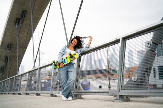young woman on the walkway with skate