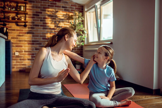 Mother and daughter doing yoga at home