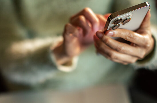 Adult hands texting on smartphone at home