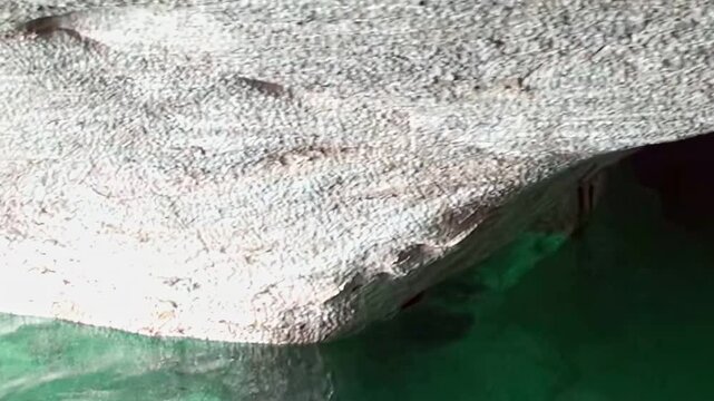 Journey into heart of Patagonia Marble Caves. Observe dazzling emerald and turquoise waters swirling around majestic, naturally carved marble formations. Serene exploration of unique geological marvel