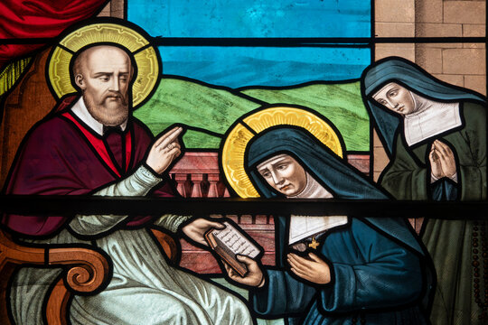 Stained glass (19th century) of Jane Frances de Chantal founder of the order of the Visitation of Mary, receives the constitution of her order from Saint Francis de Sales.