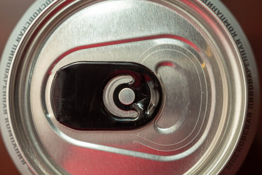 Top view of a closed aluminum beverage can with black pull tab