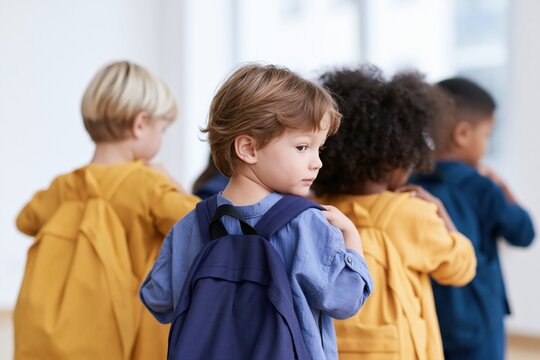 Young Scholars' Journey: A group of young scholars, each carrying a backpack, is seen from behind as they embark on their academic journey.