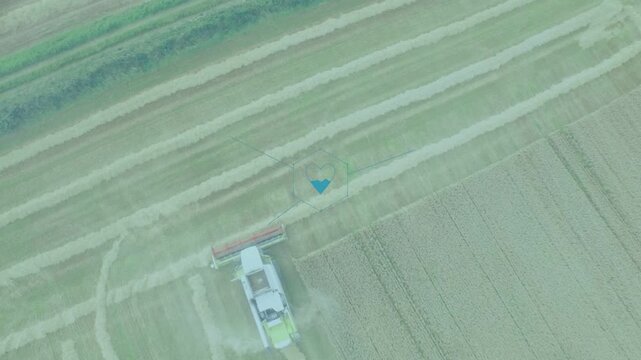Combine harvester entering bottom, cutting swaths, turning, showing UI icons for harvest monitoring