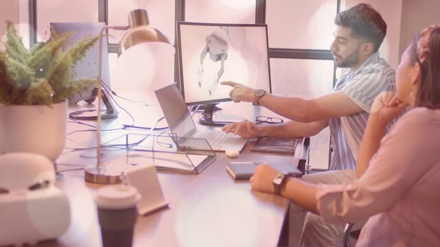 Male engineer pointing at monitor and rotating 3D prosthetic model using laptop, reviewing design