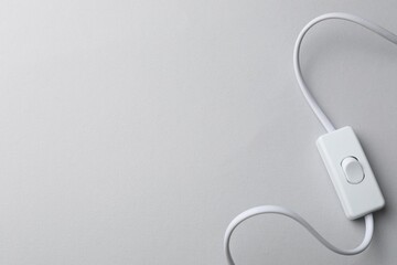 Cord switch for lamp on light grey background, top view. Space for text © New Africa